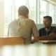two men sitting in booth mental health