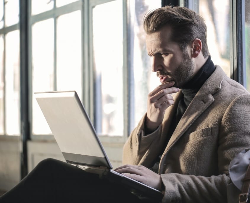 2 man with hand on chin looking at laptop bruce-mars-xj8qrWvuOEs-unsplash ineffective questions