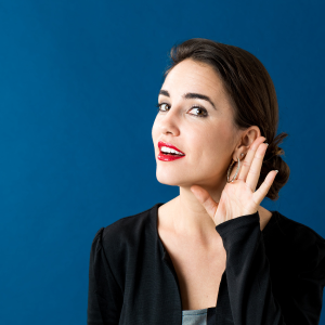Active listening, woman with hand to ear